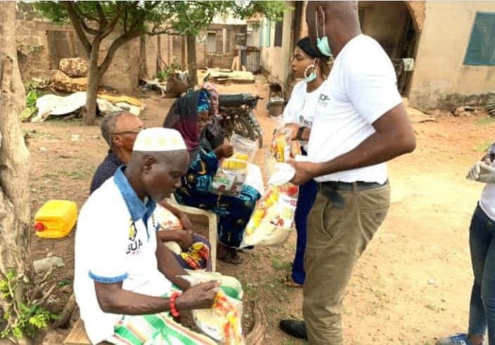 A RescueHand volunteer serving food to an elder in the community